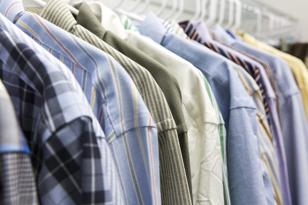 Suits hanging on a clothing rack.