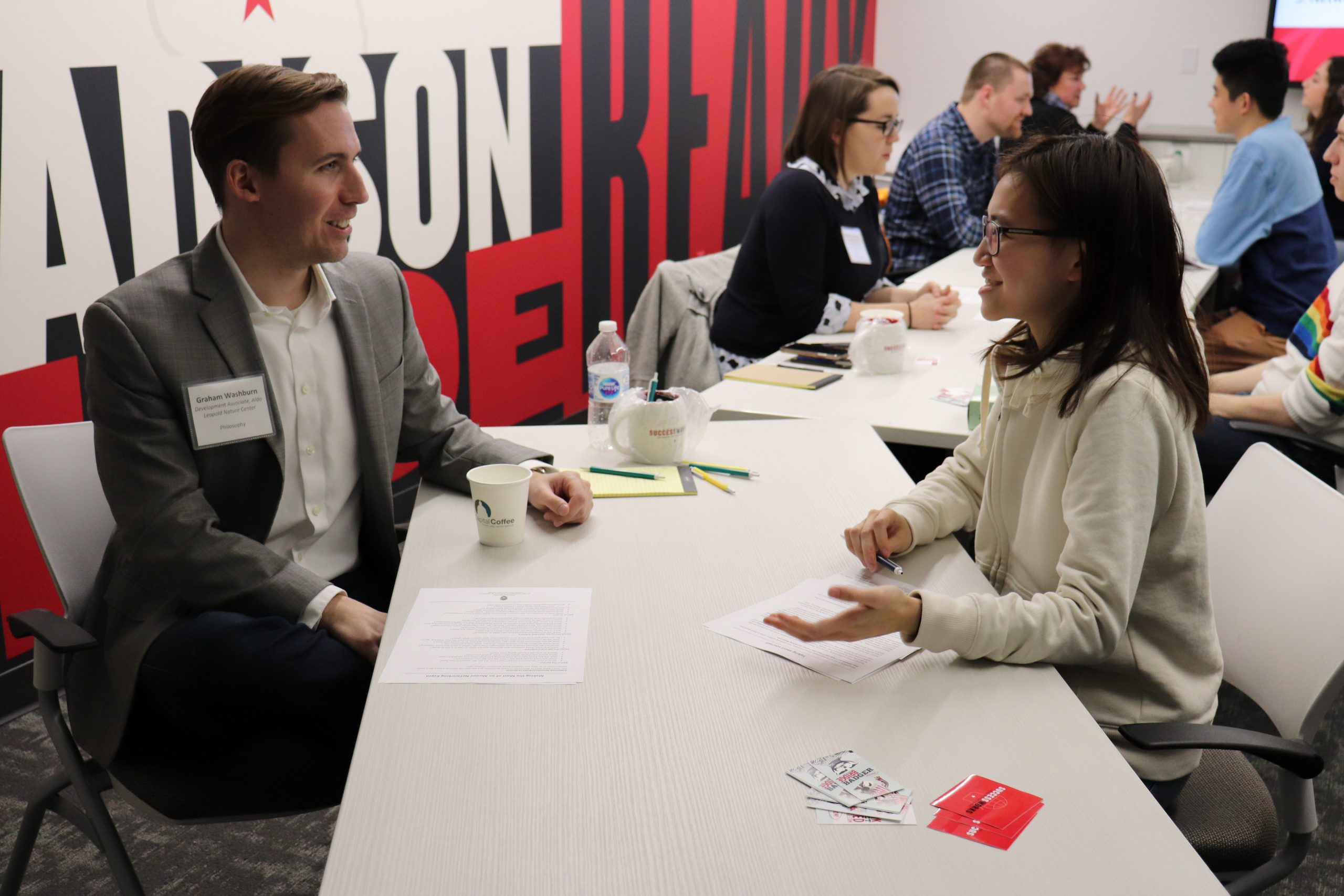 An image of a student speaking with a representative from an employer